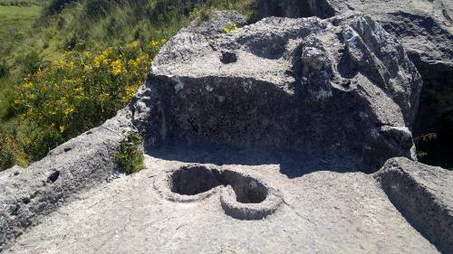 Wak'a near the Moon Temple with interesting basin.